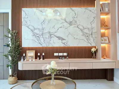 Modern living room with marble accent wall and elegant decor