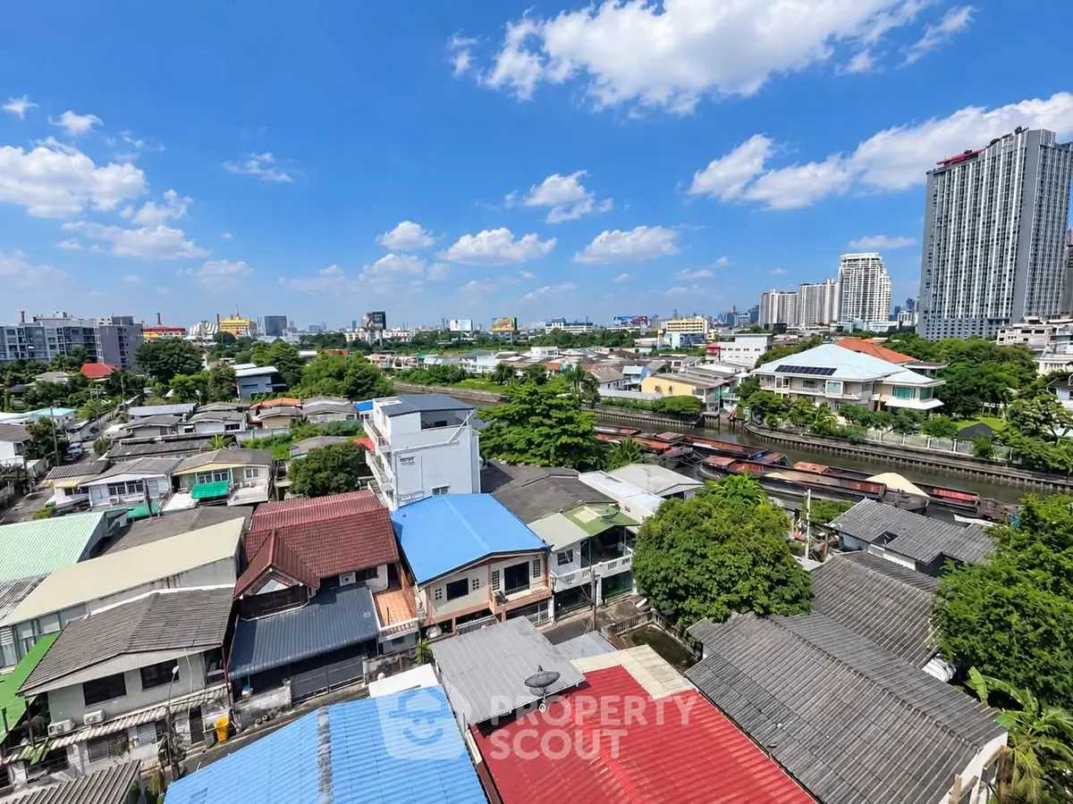 Stunning cityscape view with diverse architecture under a bright blue sky, showcasing urban living.