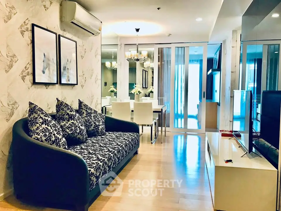 Stylish modern living room with elegant decor and open layout, featuring chic furniture and ambient lighting.