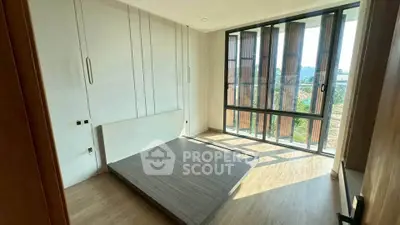 Spacious bedroom with large windows and natural light in modern home.