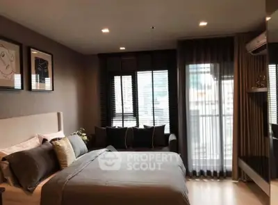 Modern bedroom with stylish decor and large windows offering city views.