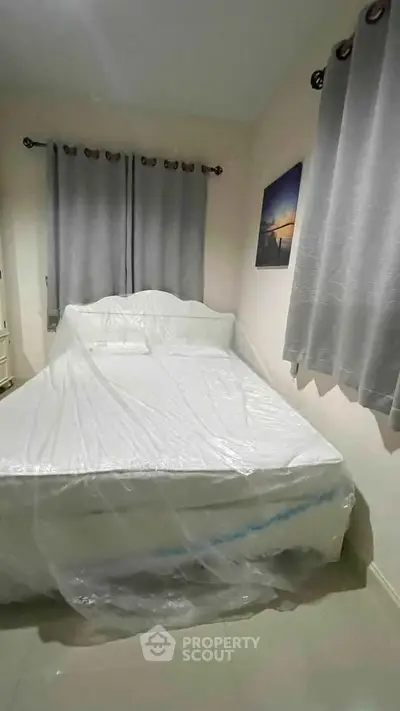 Cozy bedroom with new bed and elegant curtains, perfect for restful nights.