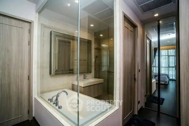Modern bathroom with glass-enclosed bathtub and sleek design