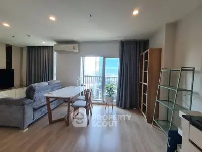 Modern living room with stylish furniture and balcony view in a high-rise apartment