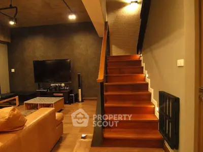 Modern living room with stylish staircase and cozy seating area