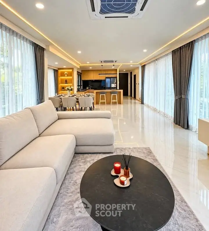 Spacious modern living room with open kitchen and elegant decor