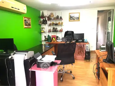 Spacious home office with vibrant green accent wall and modern furniture