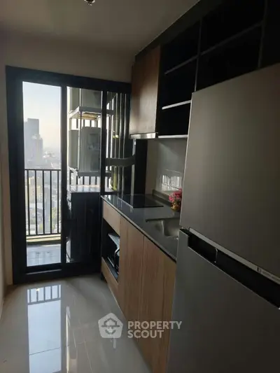 Modern kitchen with sleek appliances and city view from balcony