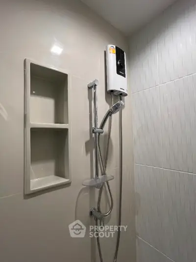 Modern bathroom with sleek shower fixtures and built-in shelving