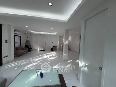 Spacious modern living room with sleek white tiles and contemporary furniture