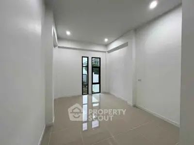 Spacious empty room with glossy tiled floor and large window