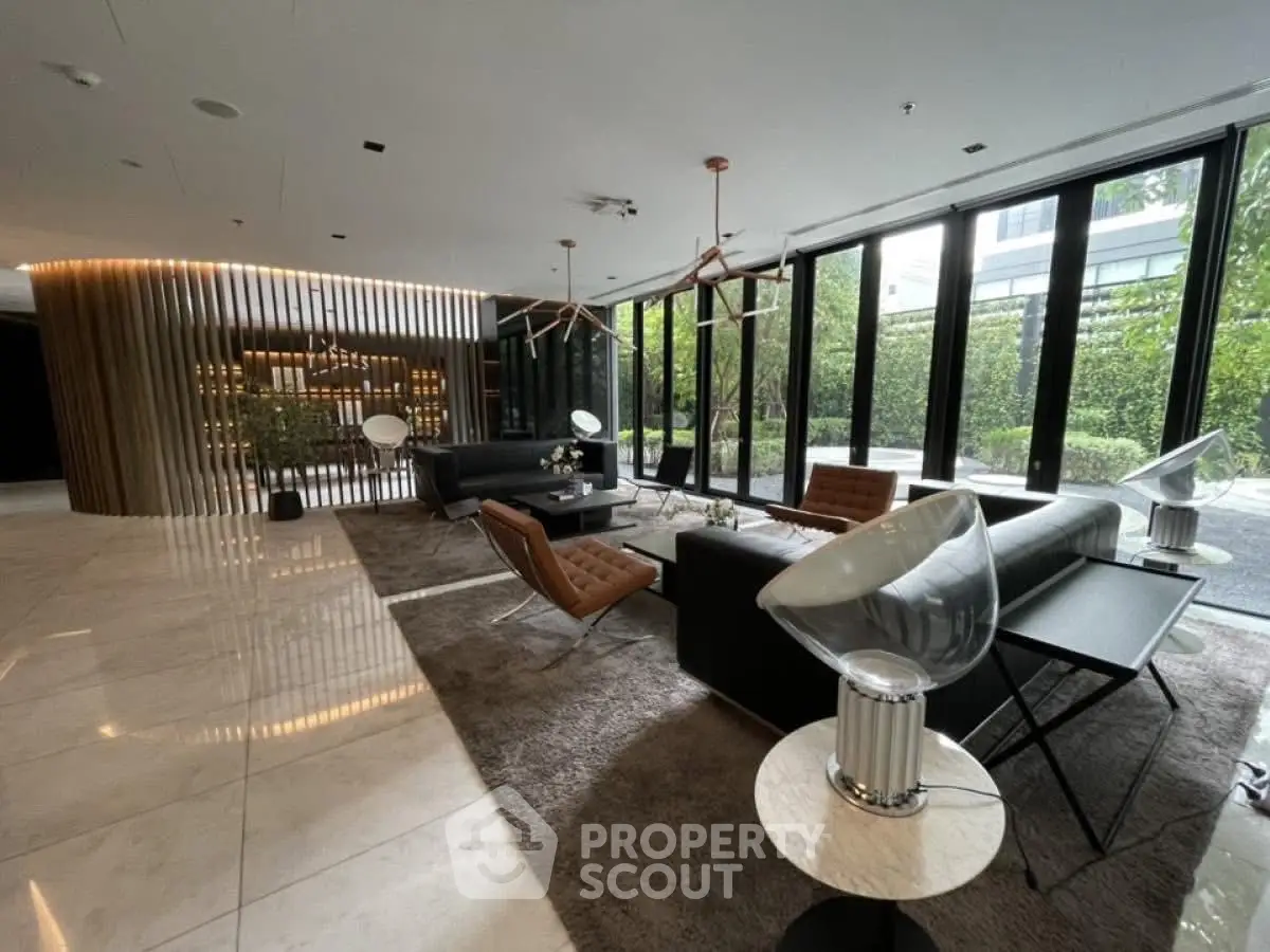 Luxurious modern living room with elegant furniture and floor-to-ceiling windows offering garden views.