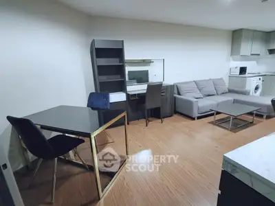 Modern living room with sleek furniture and open kitchen layout