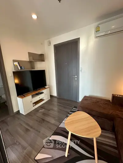 Cozy living room with modern decor and flat-screen TV, perfect for relaxation.