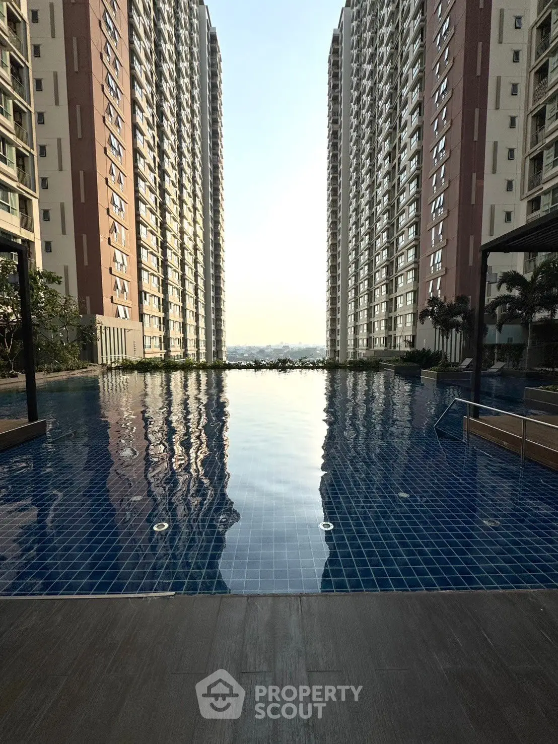 Luxurious high-rise apartment complex with stunning pool view and modern architecture.
