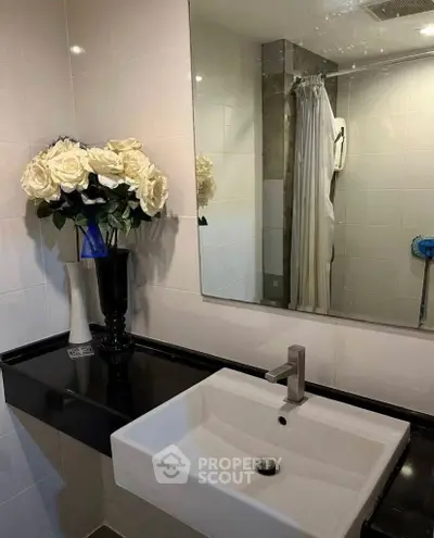 Modern bathroom with elegant sink and floral decor