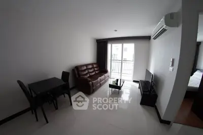 Modern living room with sleek furniture and balcony access in a stylish apartment.
