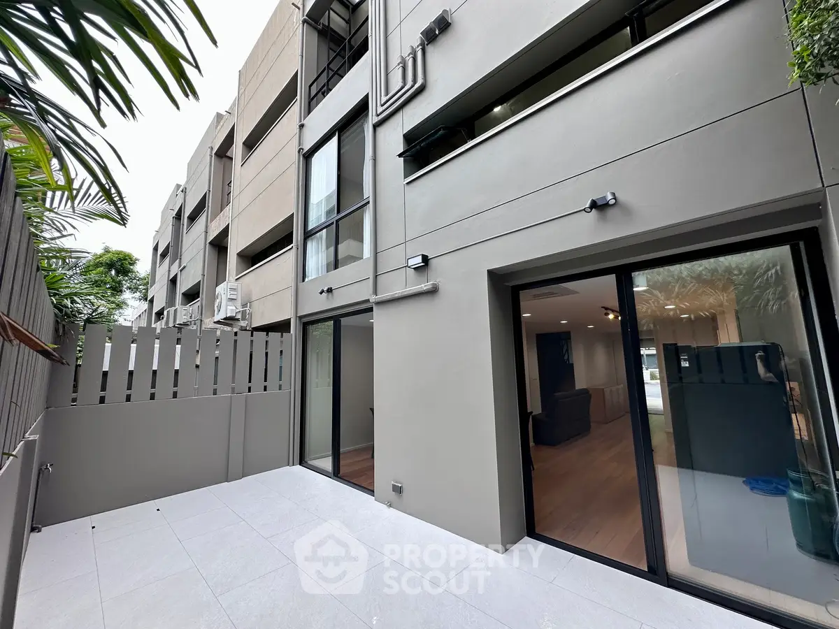 Modern townhouse exterior with spacious patio and sliding glass doors