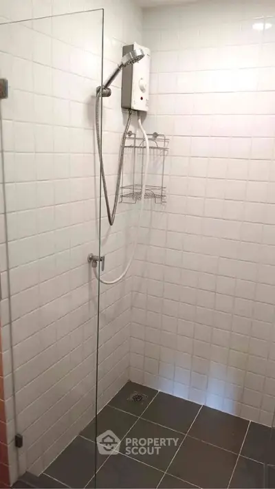 Modern bathroom with glass shower and white tiled walls