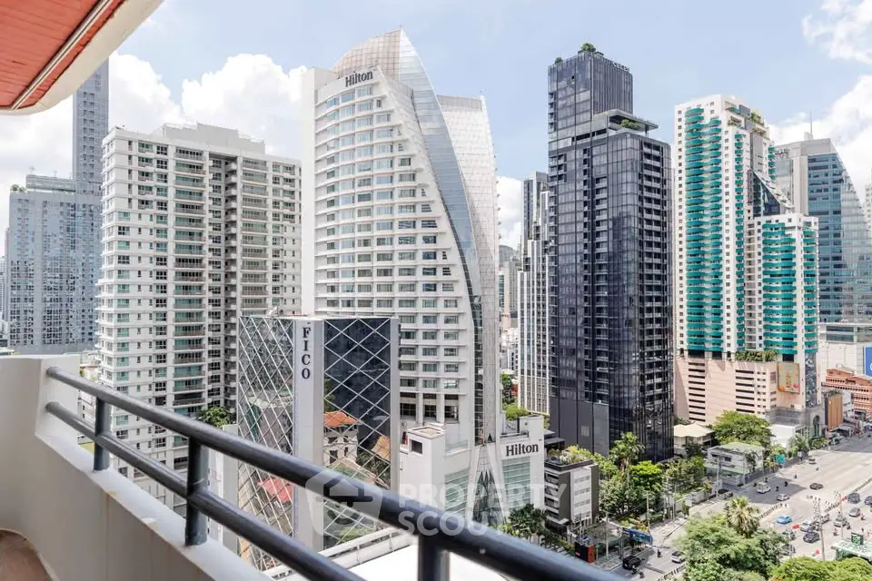 Stunning cityscape view from a high-rise balcony overlooking modern skyscrapers and vibrant urban life.
