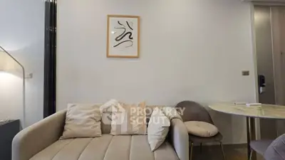 Modern living room with stylish sofa and elegant decor in a cozy apartment setting.