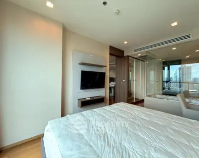Modern bedroom with city view, featuring sleek design and large windows for natural light.