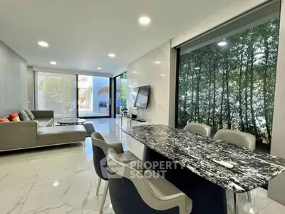 Luxurious open-plan living room with marble floors and forest view, featuring modern furniture and elegant decor.
