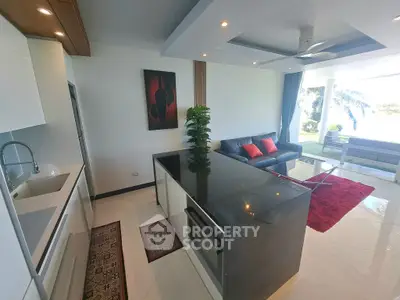 Modern open-layout living room with sleek kitchen island and stylish decor