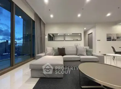 Spacious modern living room with large windows and elegant decor