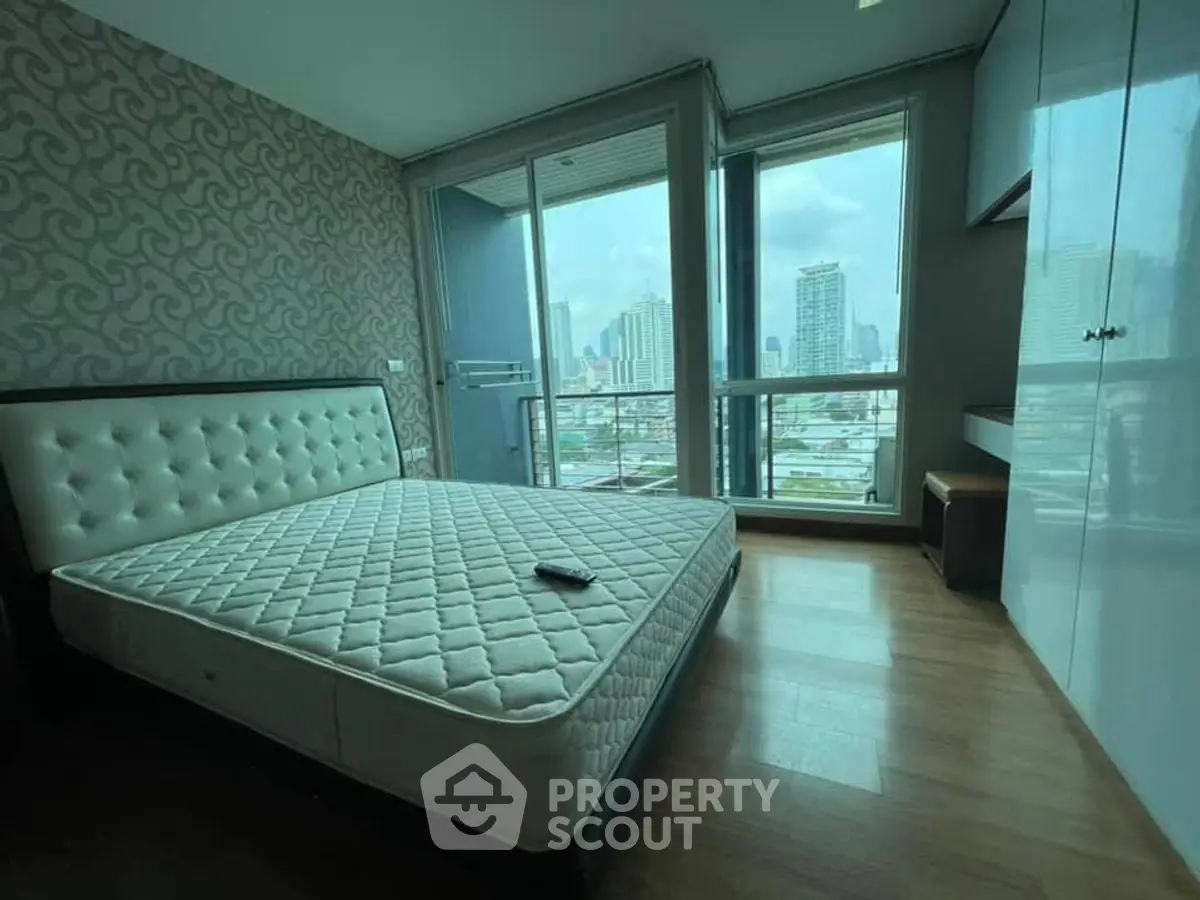 Spacious bedroom with city view and modern decor