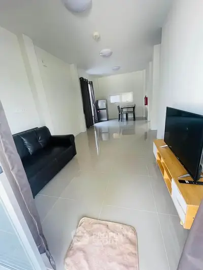 Spacious living room with modern furnishings and sleek tile flooring