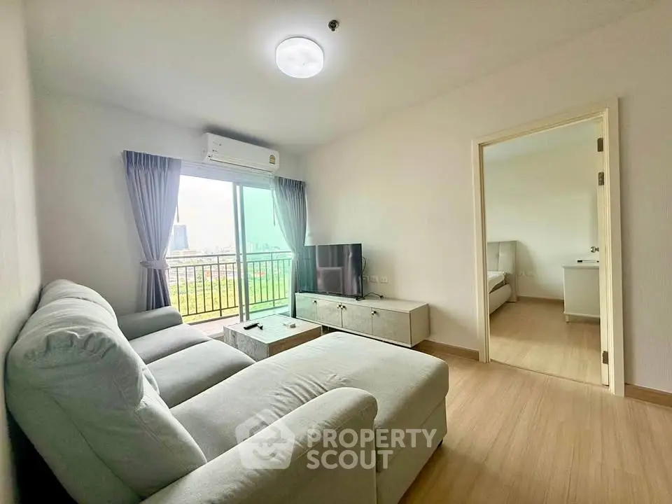 Modern living room with cozy sofa and city view balcony in a stylish apartment.