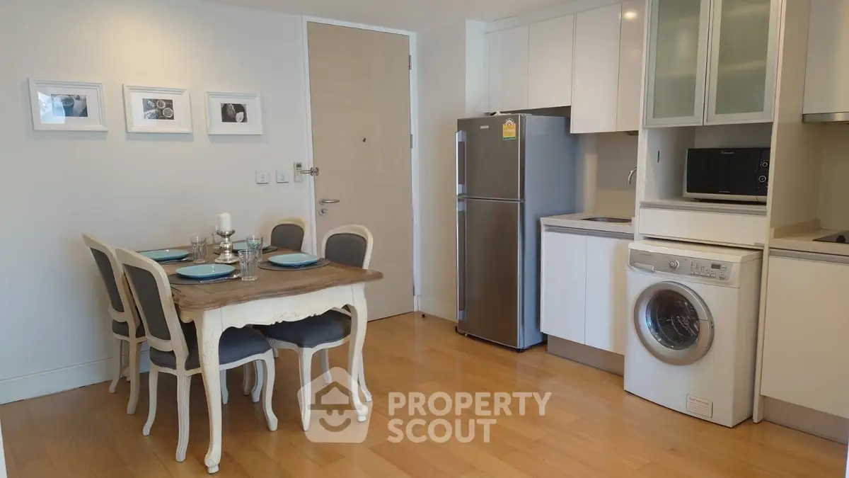 Charming kitchen with dining area, featuring modern appliances and elegant decor.