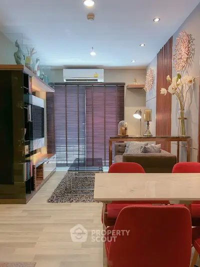 Modern living room with stylish decor and red chairs, featuring a cozy ambiance and elegant furnishings.