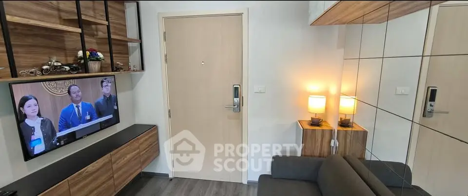 Modern living room with sleek wooden furniture and wall-mounted TV