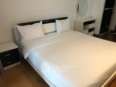 Modern bedroom with sleek furniture and cozy ambiance.