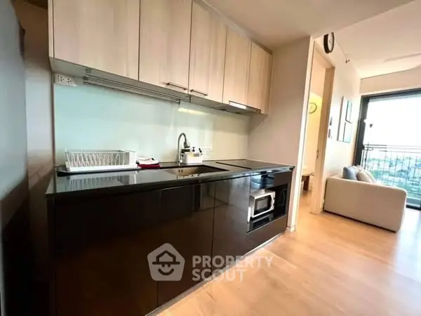 Modern kitchen with sleek cabinets and open layout in stylish apartment