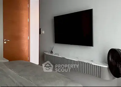 Modern bedroom with sleek TV setup and stylish decor