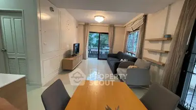 Spacious living room with modern furniture and large windows offering natural light.