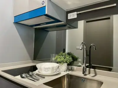 Modern kitchen with sleek design, induction cooktop, and stylish sink, perfect for contemporary living.