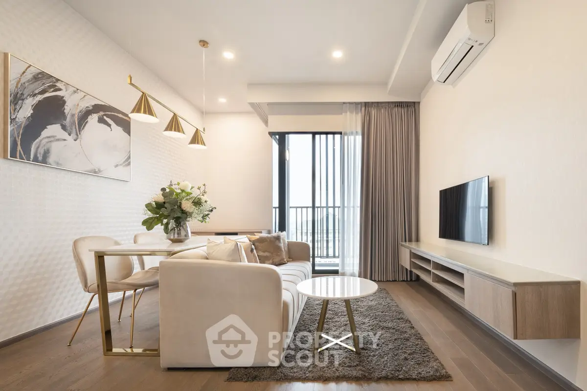 Modern living room with elegant decor, featuring a cozy sofa, stylish lighting, and a large window with a view.
