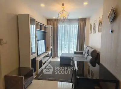 Modern living room with stylish decor and large window offering city views