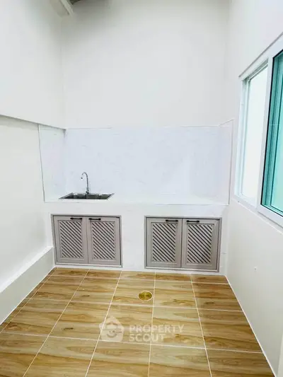 Modern kitchen with sleek cabinetry and stylish tile flooring