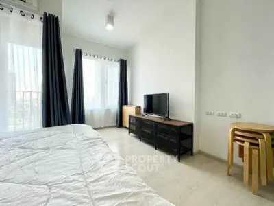 Bright and modern bedroom with TV and stylish furniture in a high-rise apartment.