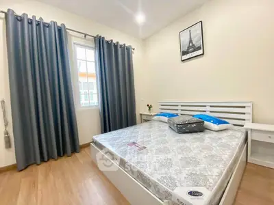 Modern bedroom with stylish decor and natural light, featuring a comfortable bed and elegant curtains.