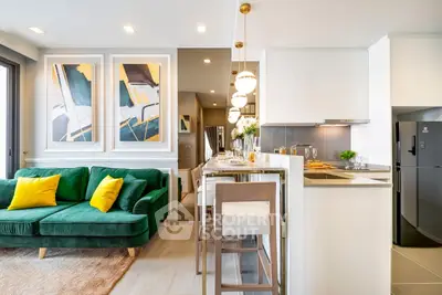 Modern open-layout kitchen and living room with stylish decor and vibrant green sofa.