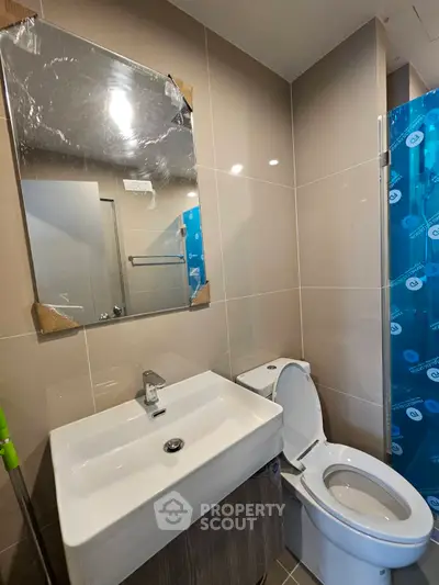 Modern bathroom with sleek fixtures and neutral tiles