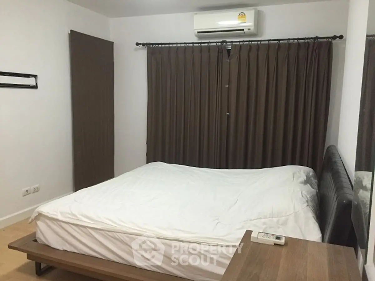 Cozy bedroom with air conditioning and modern furnishings, perfect for restful nights.