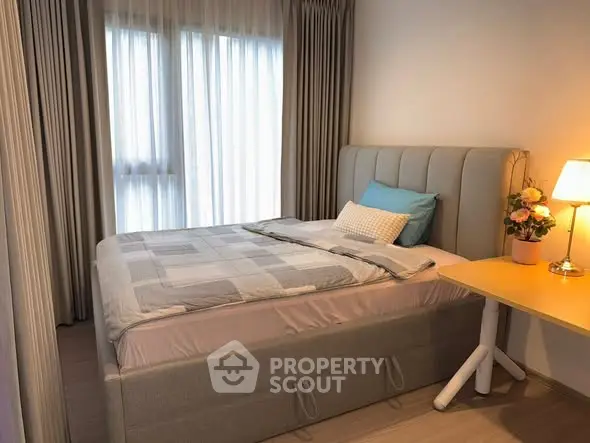 Cozy bedroom with elegant decor and natural light, perfect for relaxation.