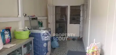 Functional laundry room with washing machine and storage space